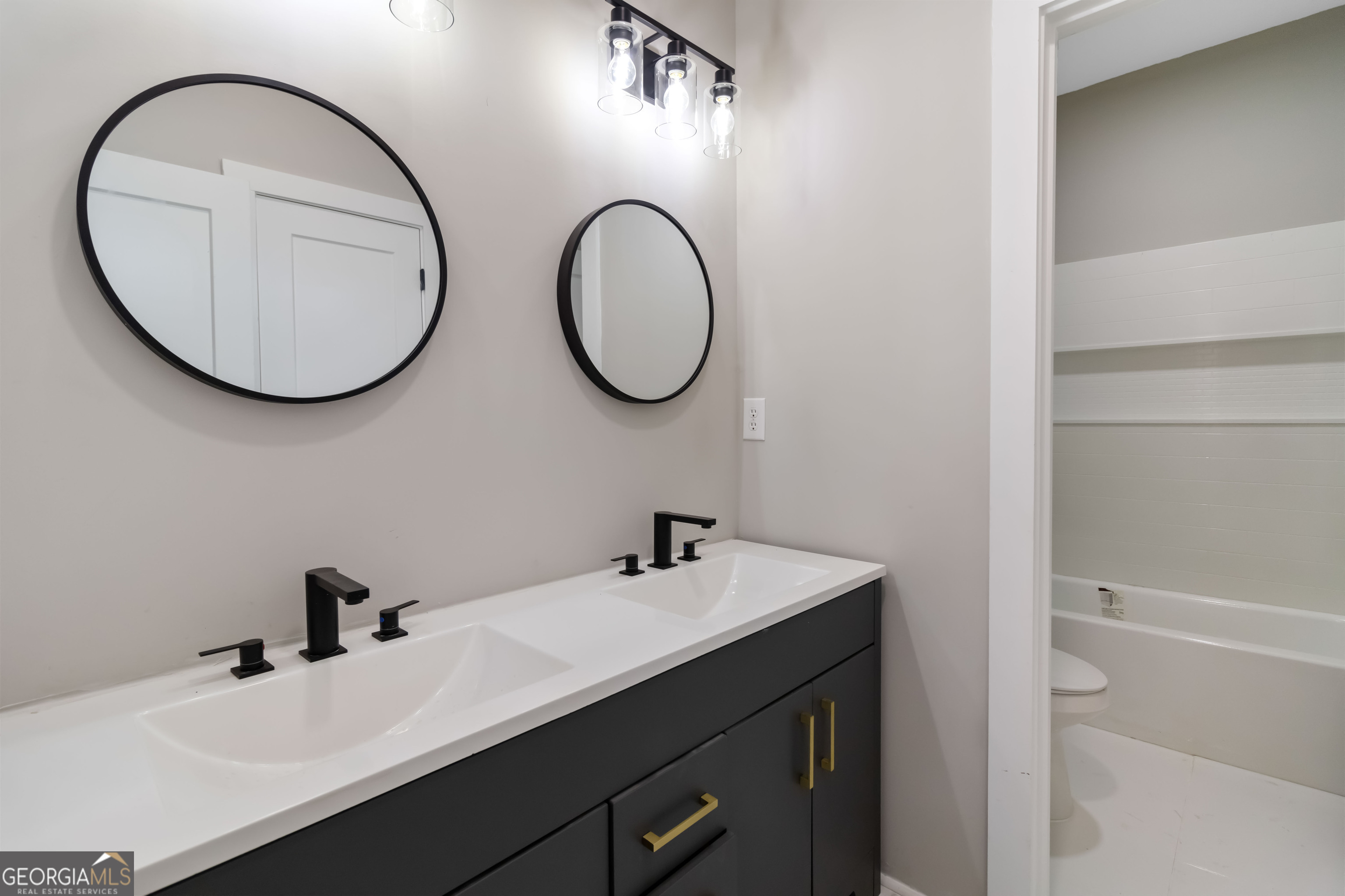 6960 Dockbridge Way Stone Mountain, GA 30087 - Photo 43 of 61 a bathroom with a sink a toilet and a mirror