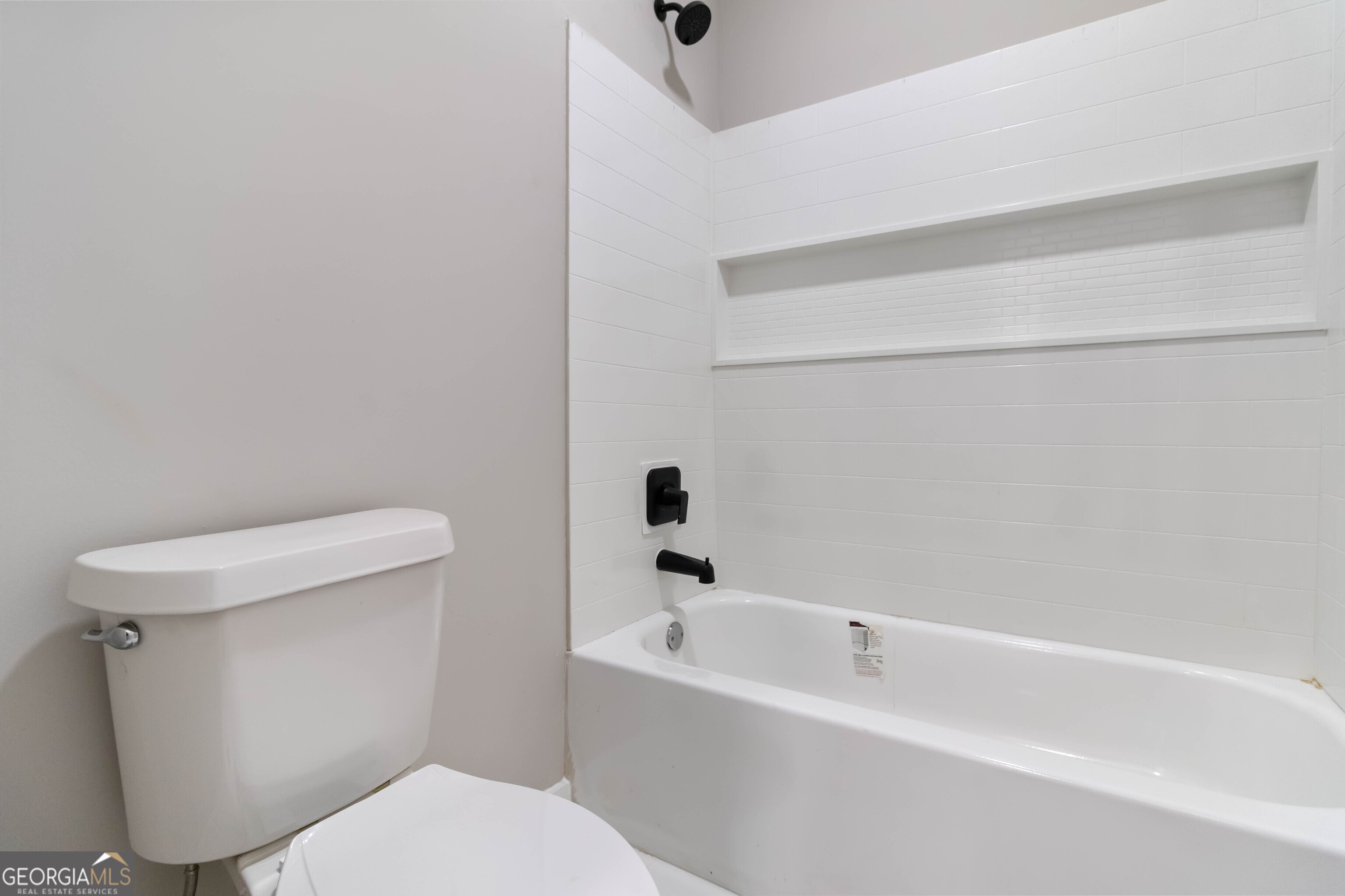6960 Dockbridge Way Stone Mountain, GA 30087 - Photo 44 of 61 a white toilet sitting next to a bath tub