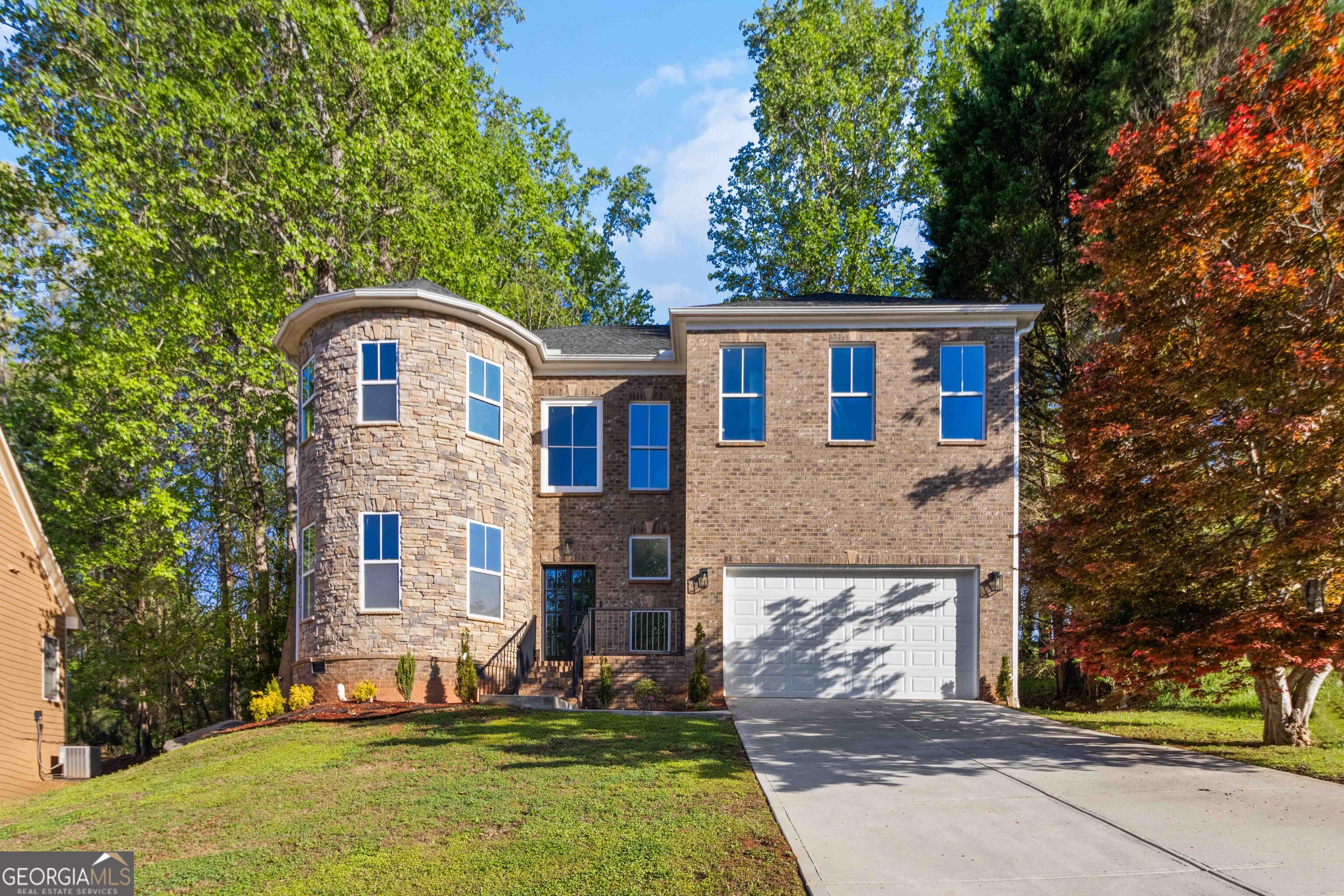 6960 Dockbridge Way Stone Mountain, GA 30087 - Photo 5 of 61 a front view of a house with a yard