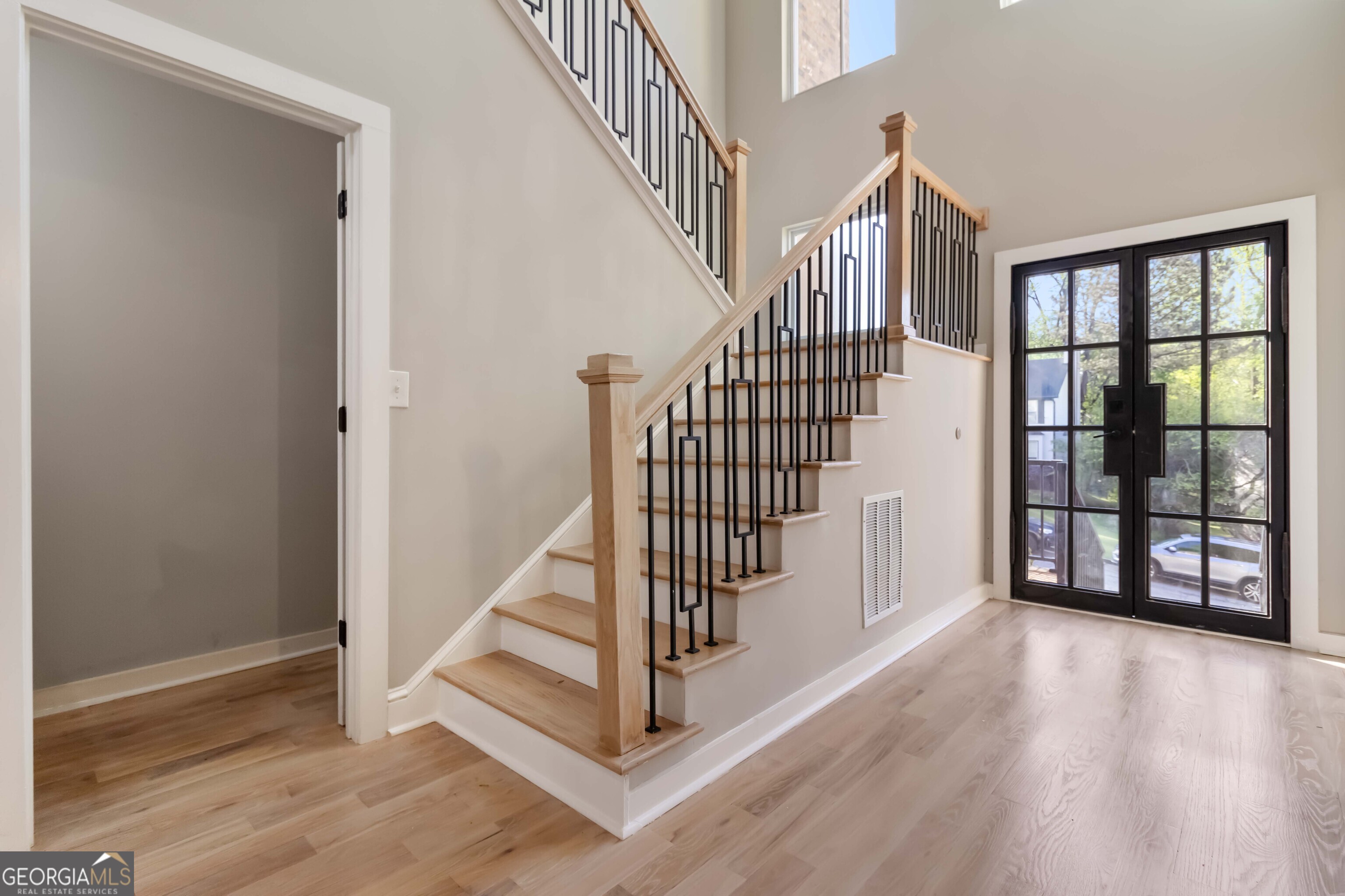 6960 Dockbridge Way Stone Mountain, GA 30087 - Photo 8 of 61 a view of entryway with stairs and wooden floor