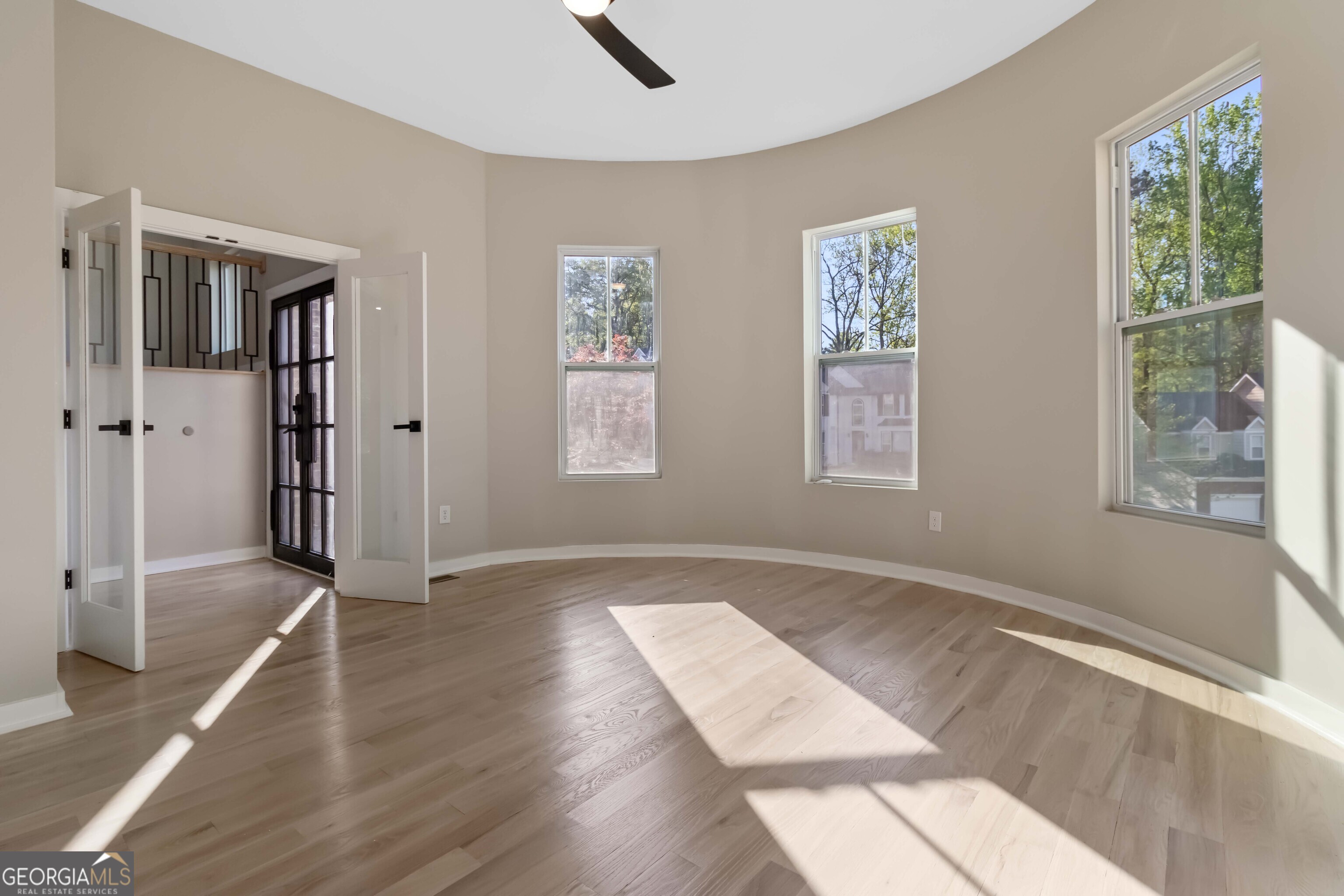 6960 Dockbridge Way Stone Mountain, GA 30087 - Photo 9 of 61 a view of an empty room with wooden floor and a window
