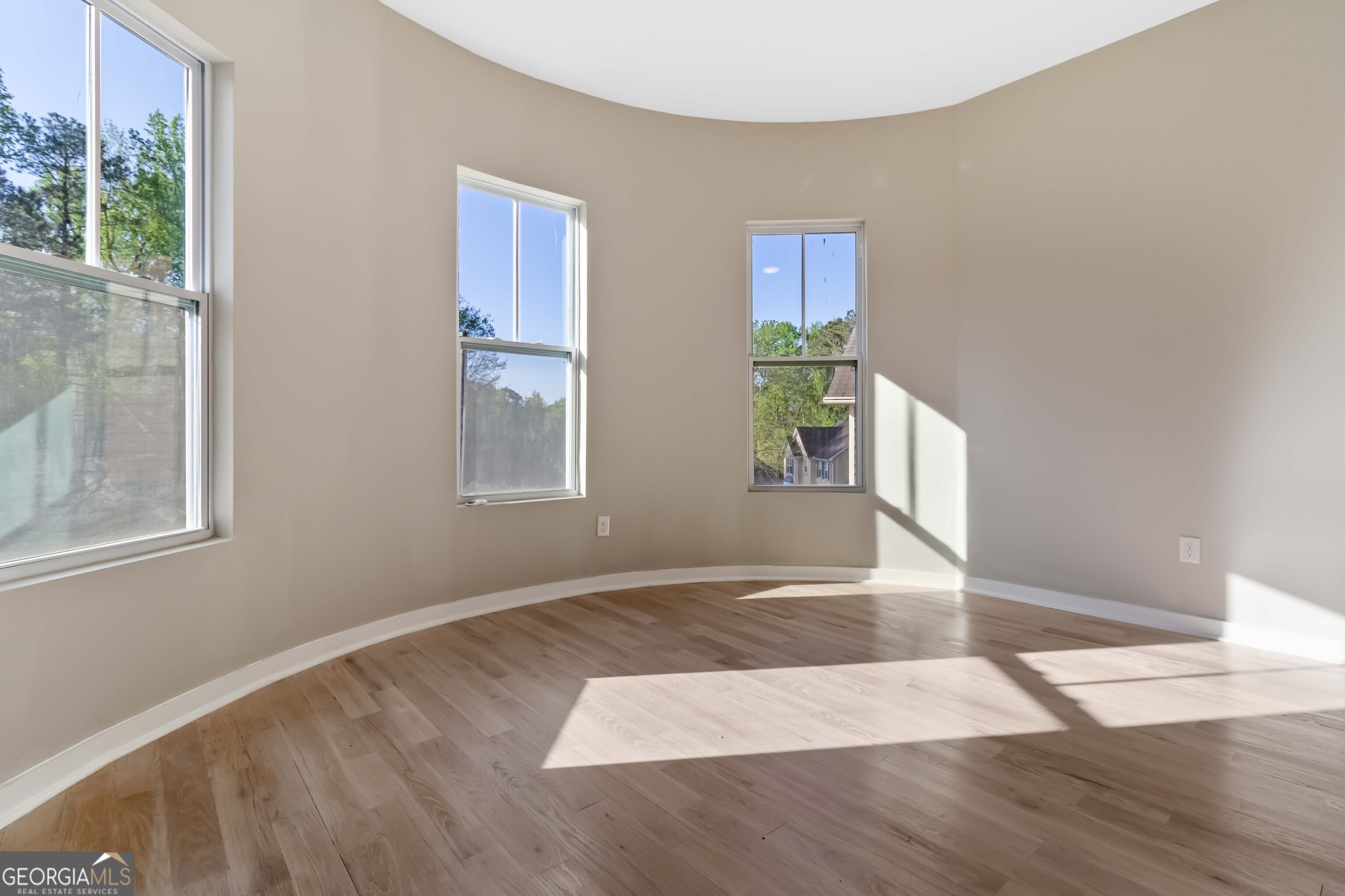 6960 Dockbridge Way Stone Mountain, GA 30087 - Photo 10 of 61 a view of an empty room with wooden floor and a window