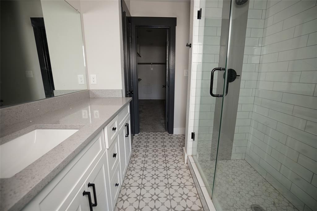 1764 Palladio Loop Princeton, TX 75407 - Photo 23 of 40 Bathroom featuring a white vanity with shaker-style cabinetry, a quartz countertop, and black hardware