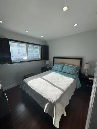 a bed sitting in a room next to a window