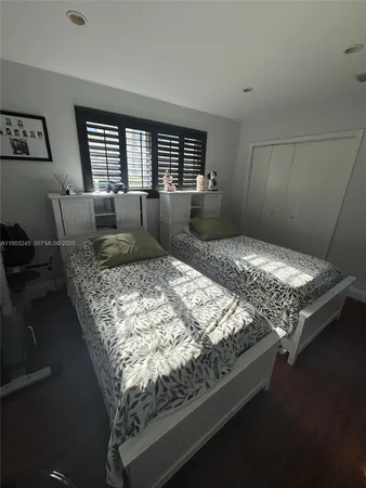 a bedroom with bed and window