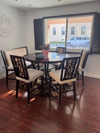 a view of a dining room with furniture window and wooden floor