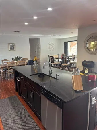 a kitchen with granite countertop a sink and a stove top oven
