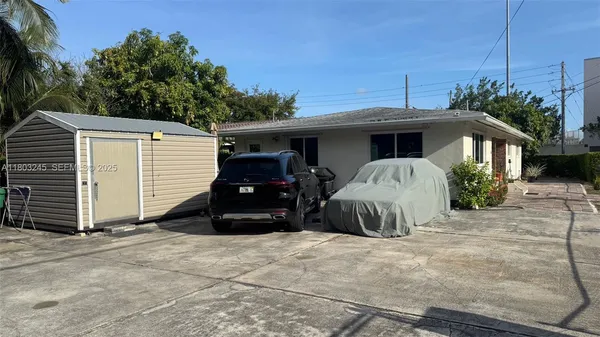 a view of a house with a bed and a garage
