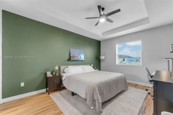 a bedroom with a bed and a painting on the wall