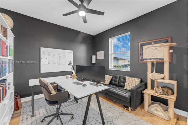 a living room with furniture and next to a window