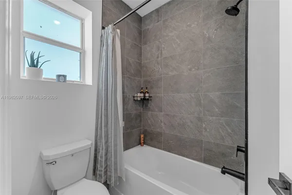 a bathroom with a toilet and shower