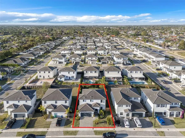 an aerial view of residential houses with outdoor space