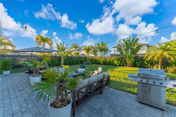 a view of a backyard with plants and a patio