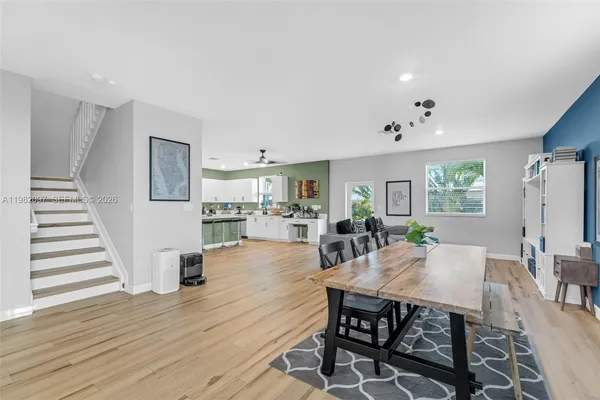 a view of a dining room with furniture and wooden floor