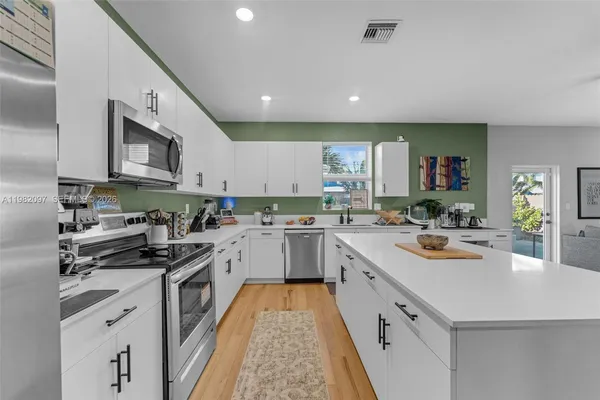 a kitchen with stainless steel appliances granite countertop a sink and cabinets