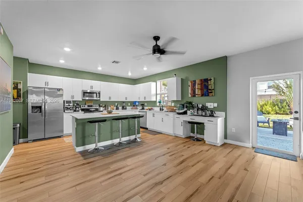 a kitchen with stainless steel appliances kitchen island wooden cabinets and granite counter tops