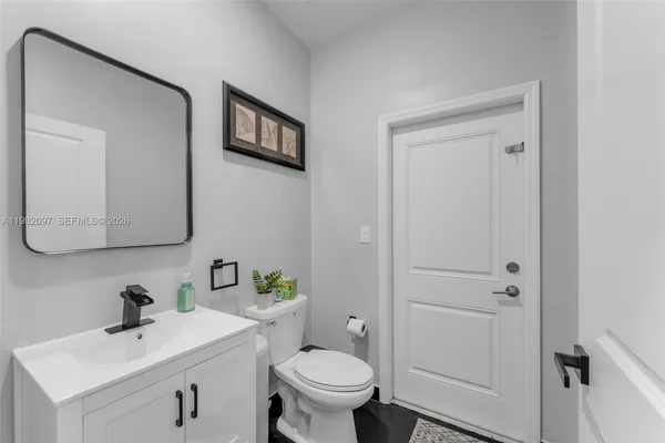 a bathroom with a toilet sink and mirror