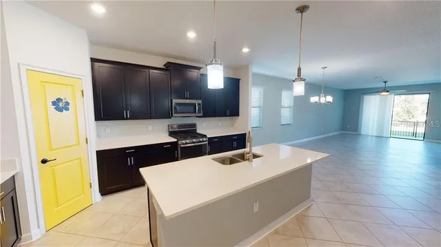 a kitchen with a refrigerator and a sink