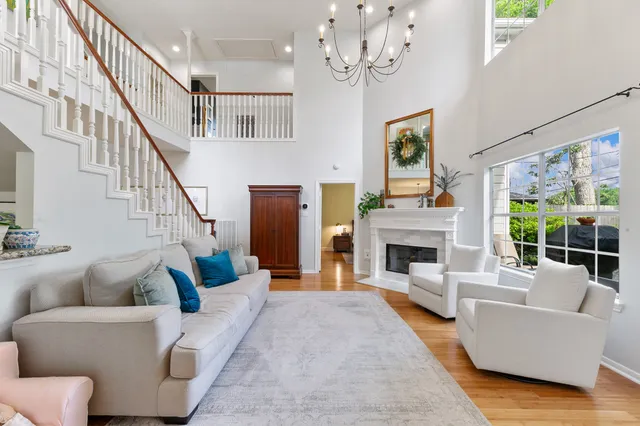 a kitchen with stainless steel appliances granite countertop a refrigerator a stove a sink dishwasher a dining table and chairs with wooden floor