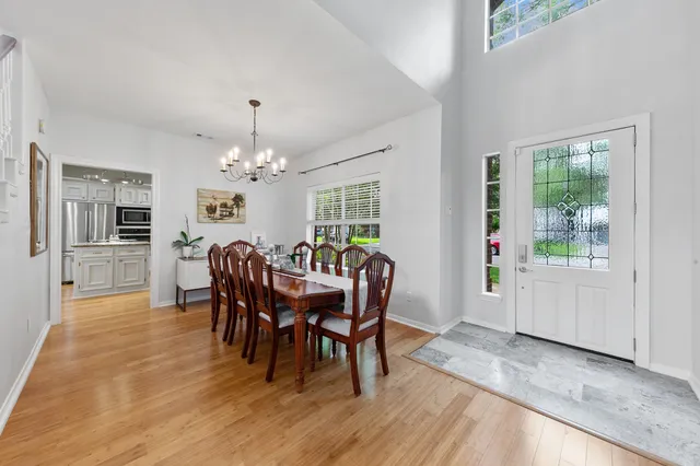 a view of a hallway with wooden floor and stairs