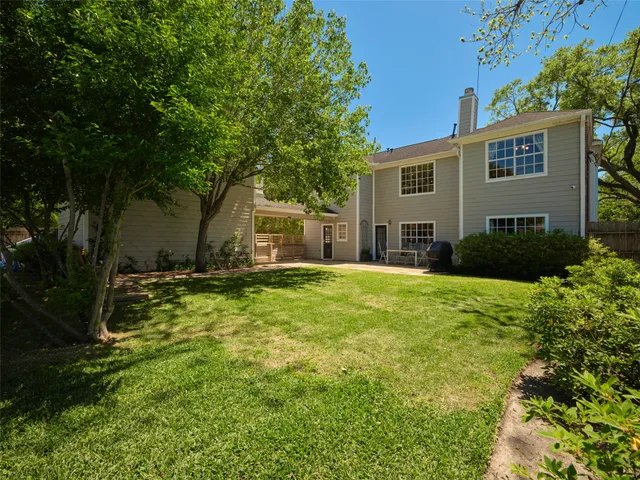 a bathroom with a granite countertop toilet and a sink