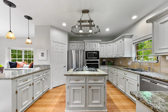 a living room with couches furniture and a large window