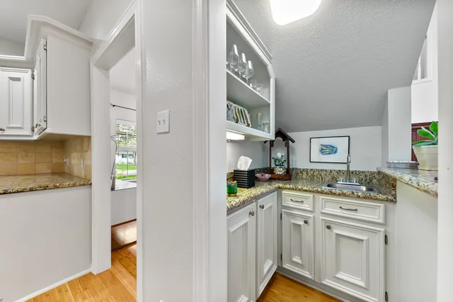 a kitchen with stainless steel appliances kitchen island granite countertop a sink and cabinets