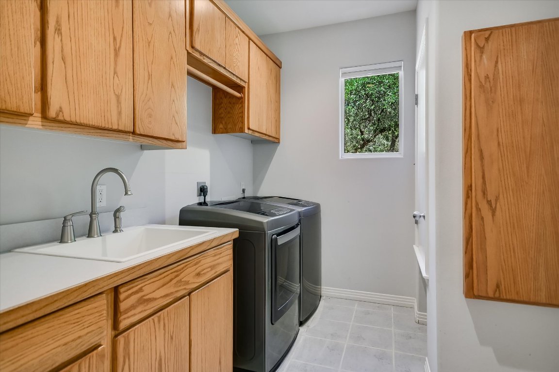 112 Twin Saddles Dripping Springs, TX 78620 - Photo 11 of 29 a kitchen with stainless steel appliances granite countertop a sink stove and microwave