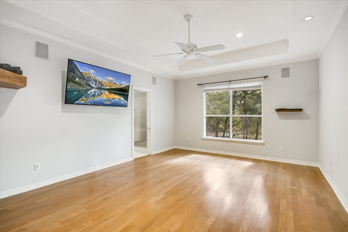 112 Twin Saddles Dripping Springs, TX 78620 - Photo 15 of 29 a view of an empty room with a window and wooden floor