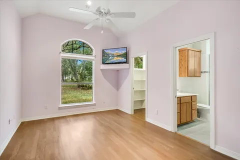 a bedroom with a large bed and a window
