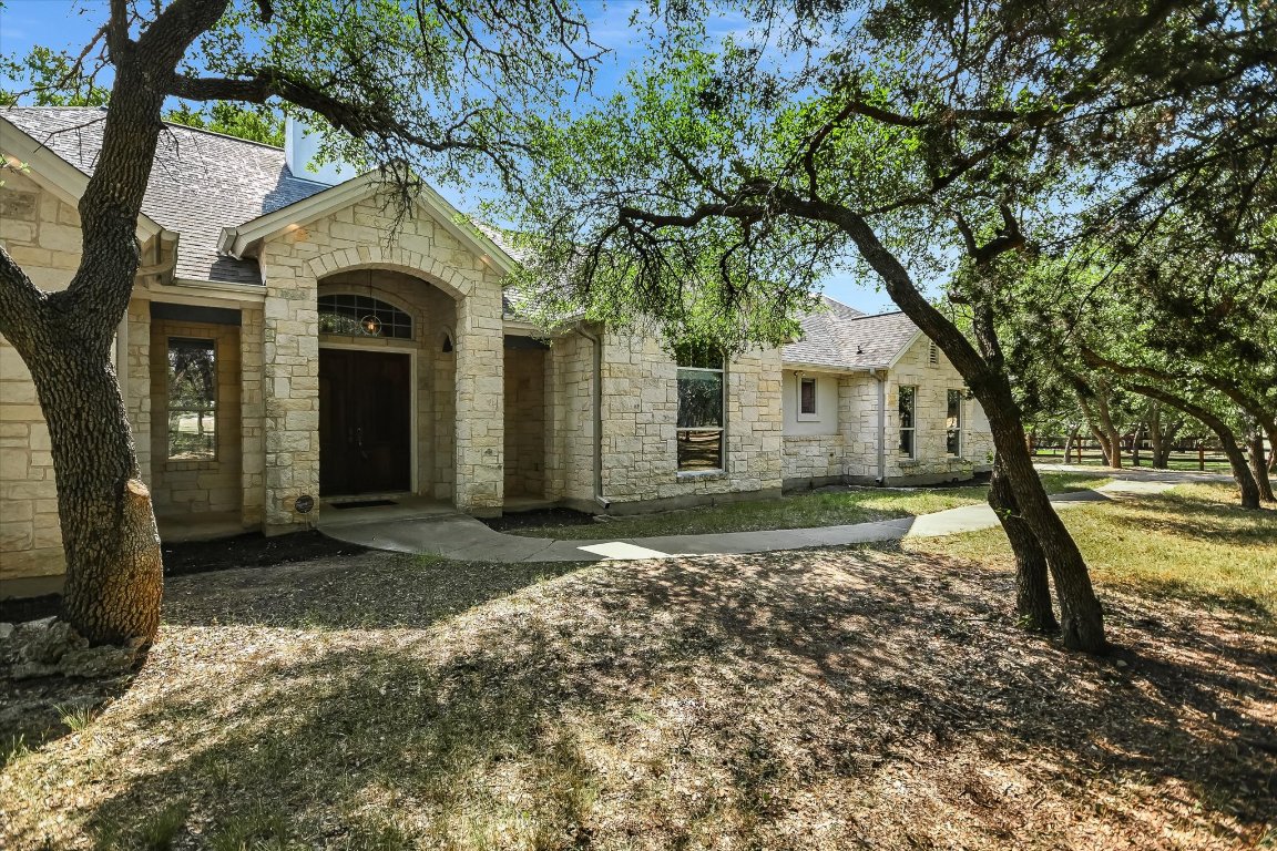 112 Twin Saddles Dripping Springs, TX 78620 - Photo 2 of 29 a house with trees in front of it