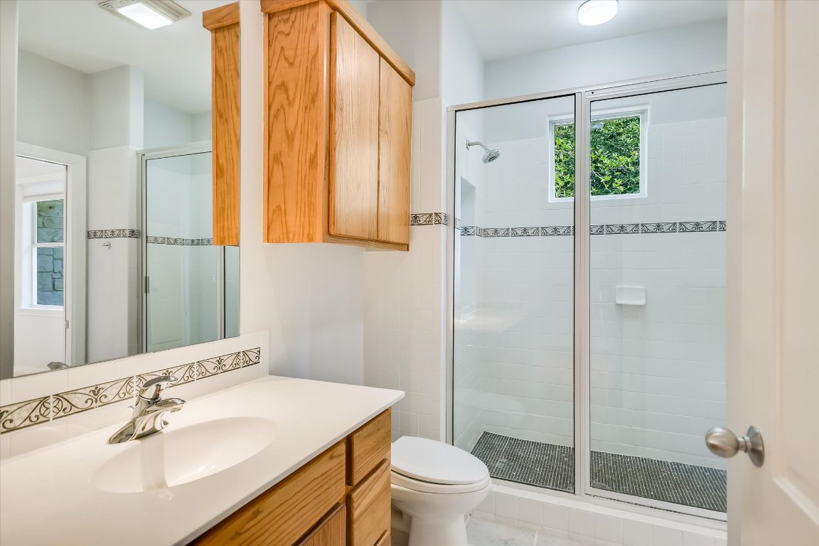 112 Twin Saddles Dripping Springs, TX 78620 - Photo 22 of 29 a bathroom with a sink toilet and shower