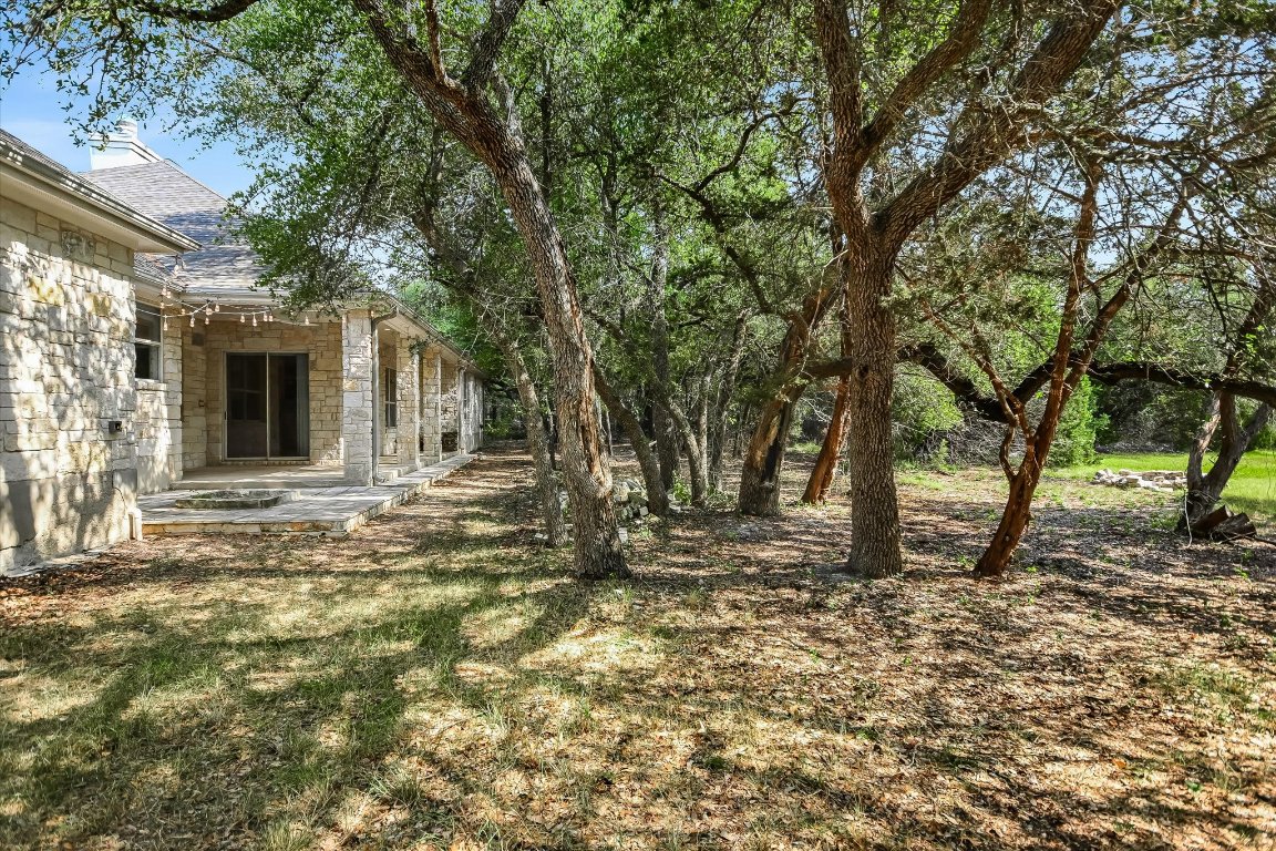 112 Twin Saddles Dripping Springs, TX 78620 - Photo 26 of 29 a view of a backyard with large tree