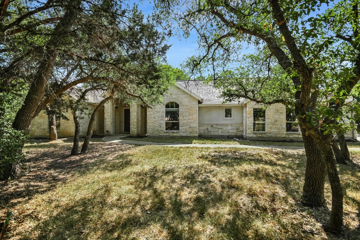 112 Twin Saddles Dripping Springs, TX 78620 - Photo 28 of 29 a house with trees in front of it