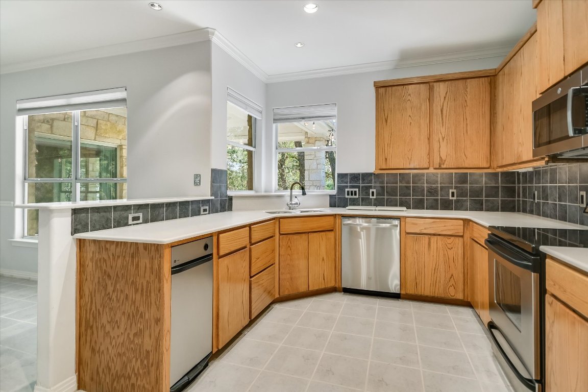 112 Twin Saddles Dripping Springs, TX 78620 - Photo 10 of 29 a kitchen that has a sink and a stove in it