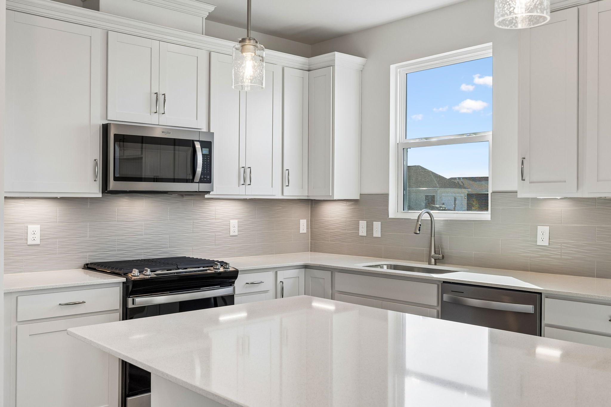 a kitchen with stainless steel appliances a stove a microwave and cabinets