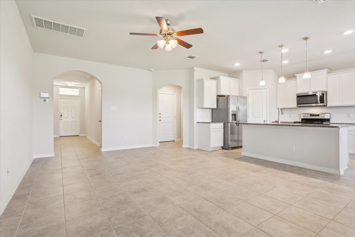 5830 Copano Road Belton, TX 76513 - Photo 9 of 34 Kitchen featuring visible vents, arched walkways, appliances with stainless steel finishes, a ceiling fan, and light tile patterned flooring