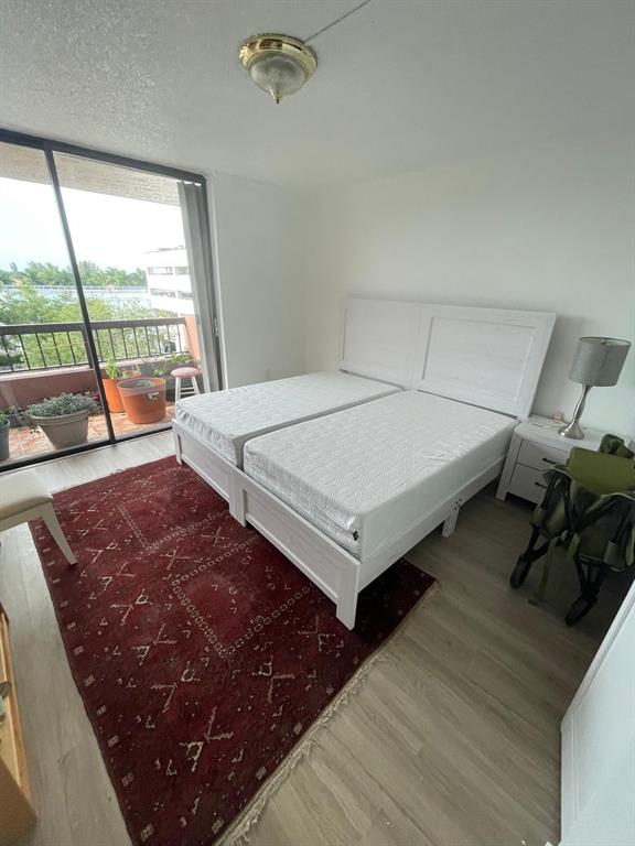 7040 Coral Way Miami, FL 33155 - Photo 7 of 10 a bed sitting in a bedroom next to a window