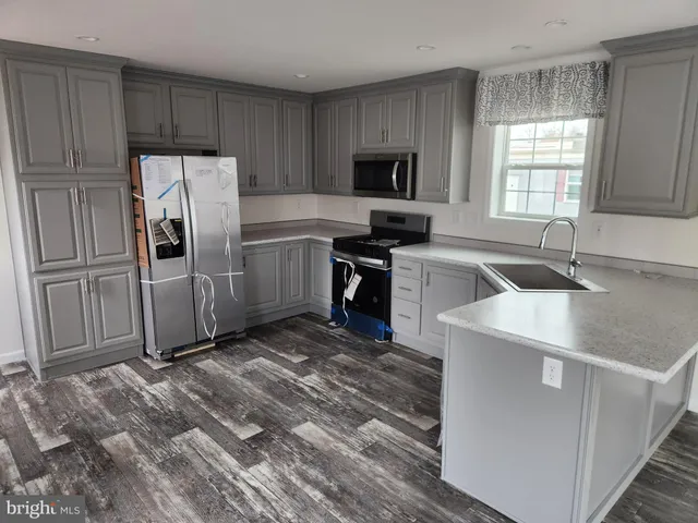 a kitchen with a refrigerator sink and microwave