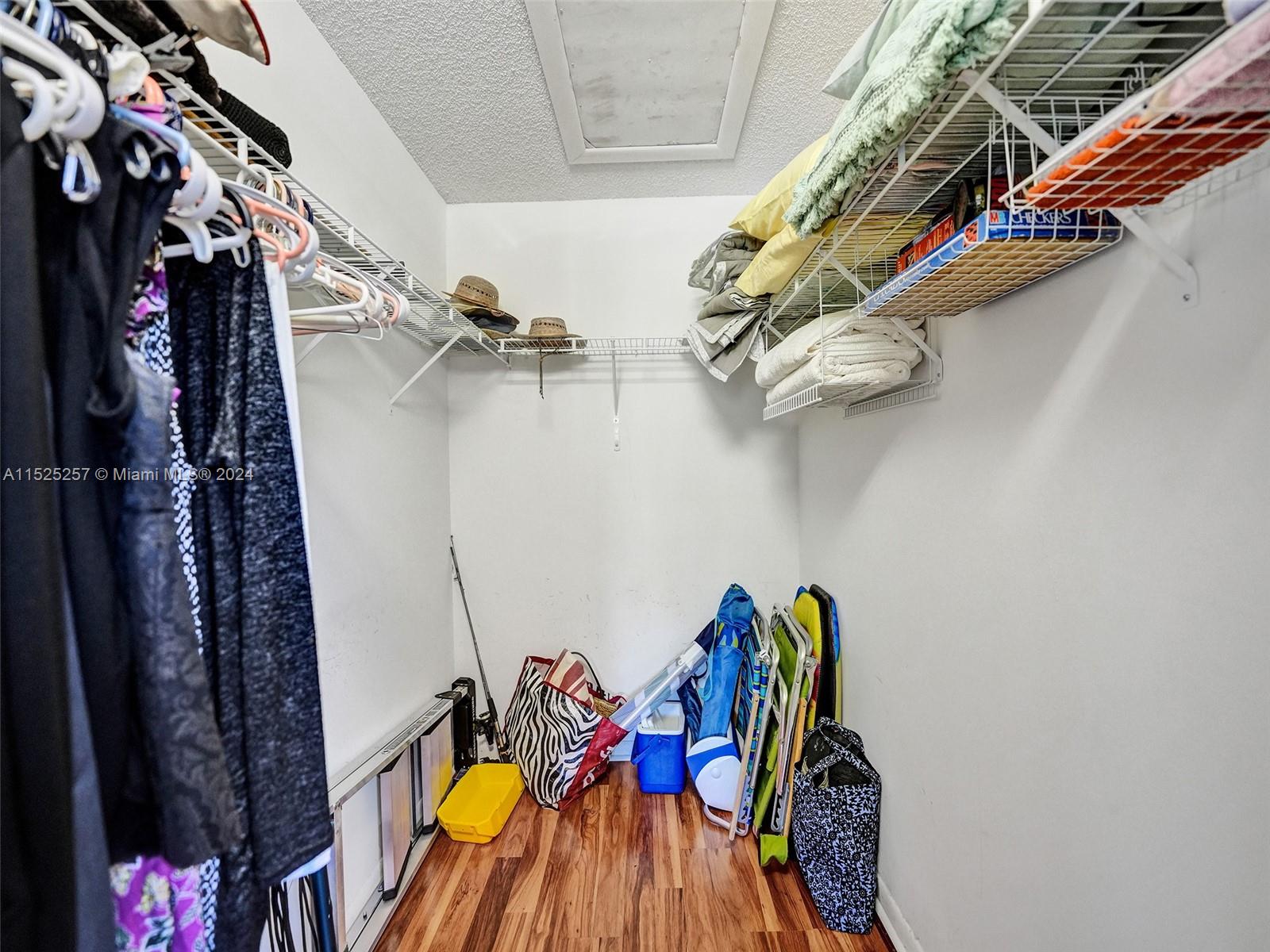 9480 Boca Cove Circle, Unit 416 Boca Raton, FL 33428 - Photo 13 of 25 a view of walk in closet with clothes and shoes