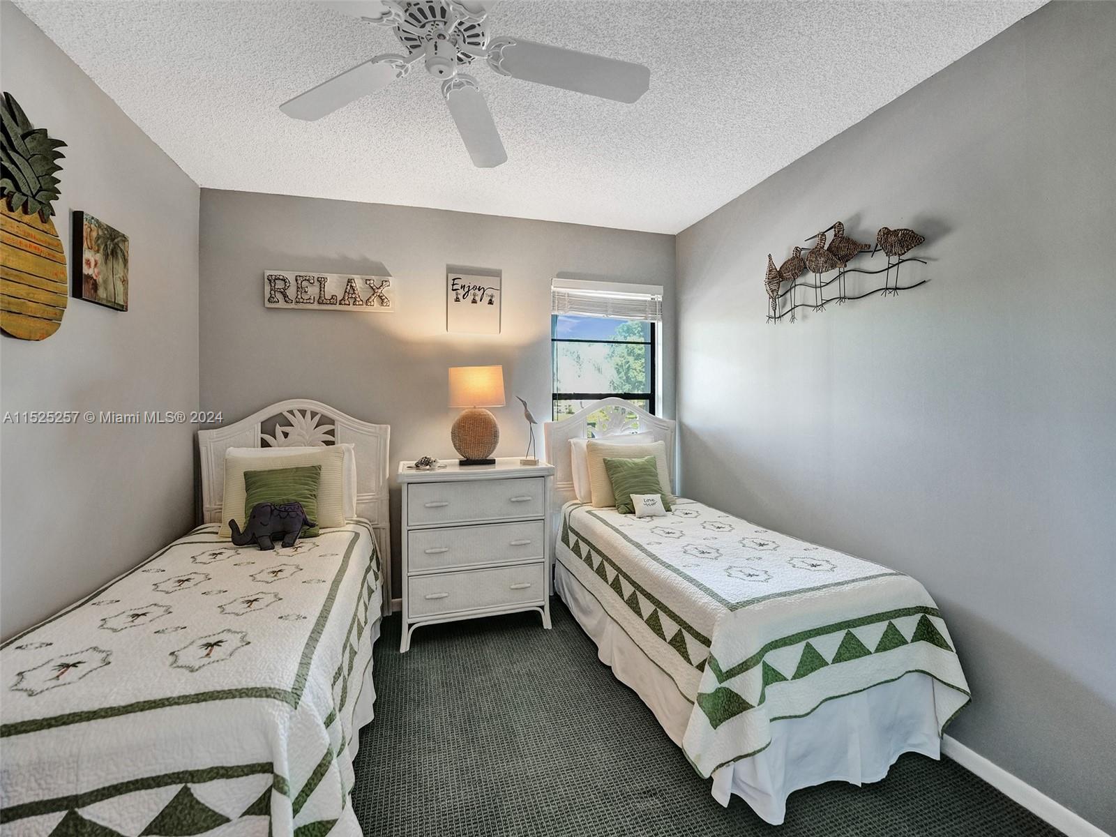 9480 Boca Cove Circle, Unit 416 Boca Raton, FL 33428 - Photo 15 of 25 a bedroom with a bed and a chandelier