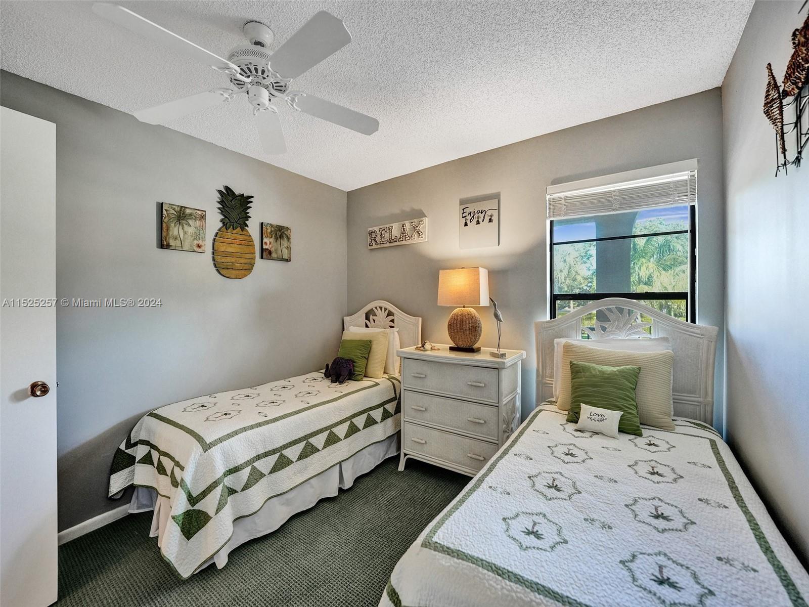 9480 Boca Cove Circle, Unit 416 Boca Raton, FL 33428 - Photo 16 of 25 a bedroom with a bed and a chandelier