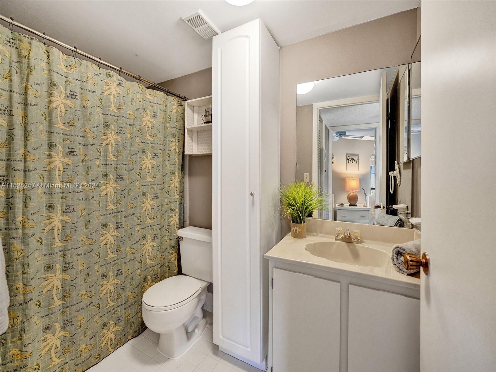 9480 Boca Cove Circle, Unit 416 Boca Raton, FL 33428 - Photo 17 of 25 a bathroom with a sink a toilet and shower