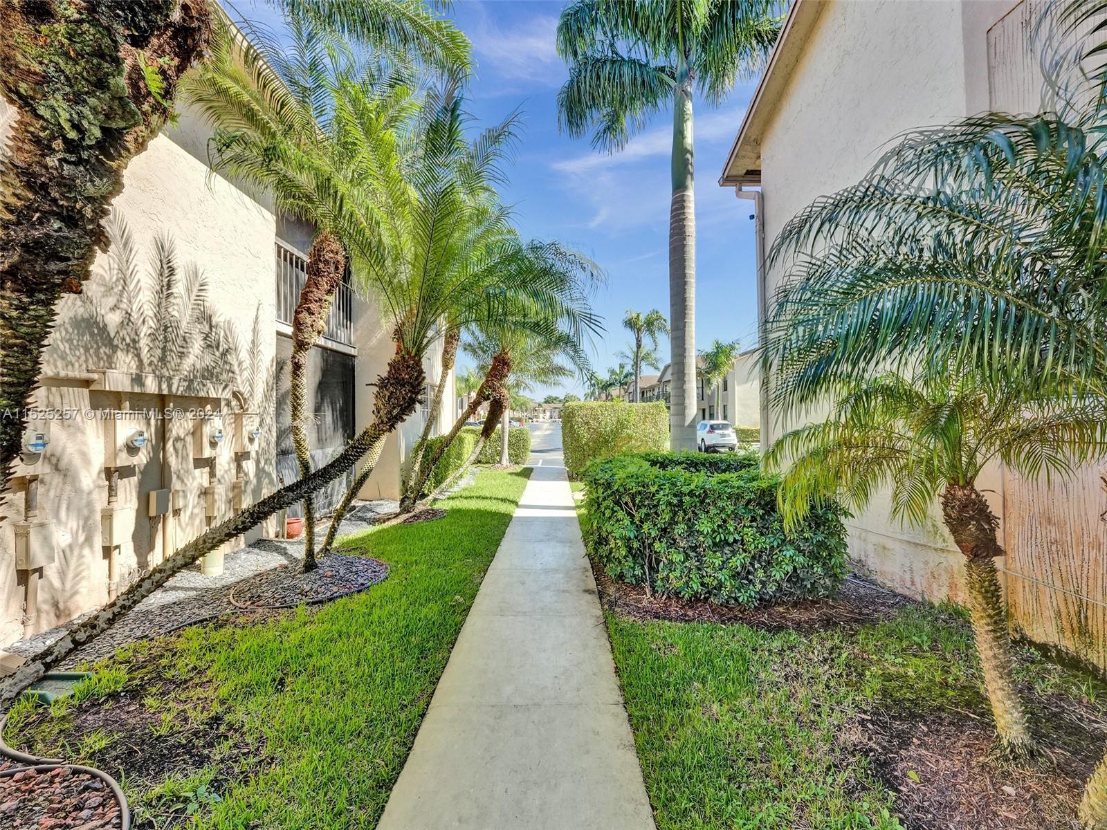 9480 Boca Cove Circle, Unit 416 Boca Raton, FL 33428 - Photo 20 of 25 a view of a pathway with a yard