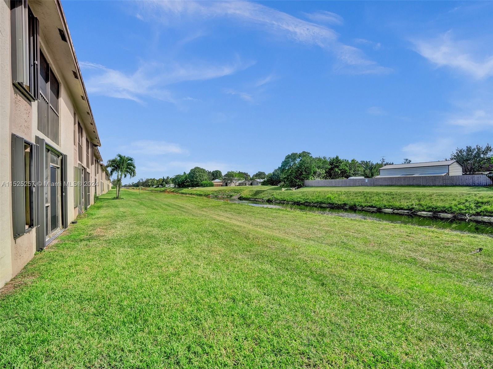 9480 Boca Cove Circle, Unit 416 Boca Raton, FL 33428 - Photo 21 of 25 a view of a grassy field with trees