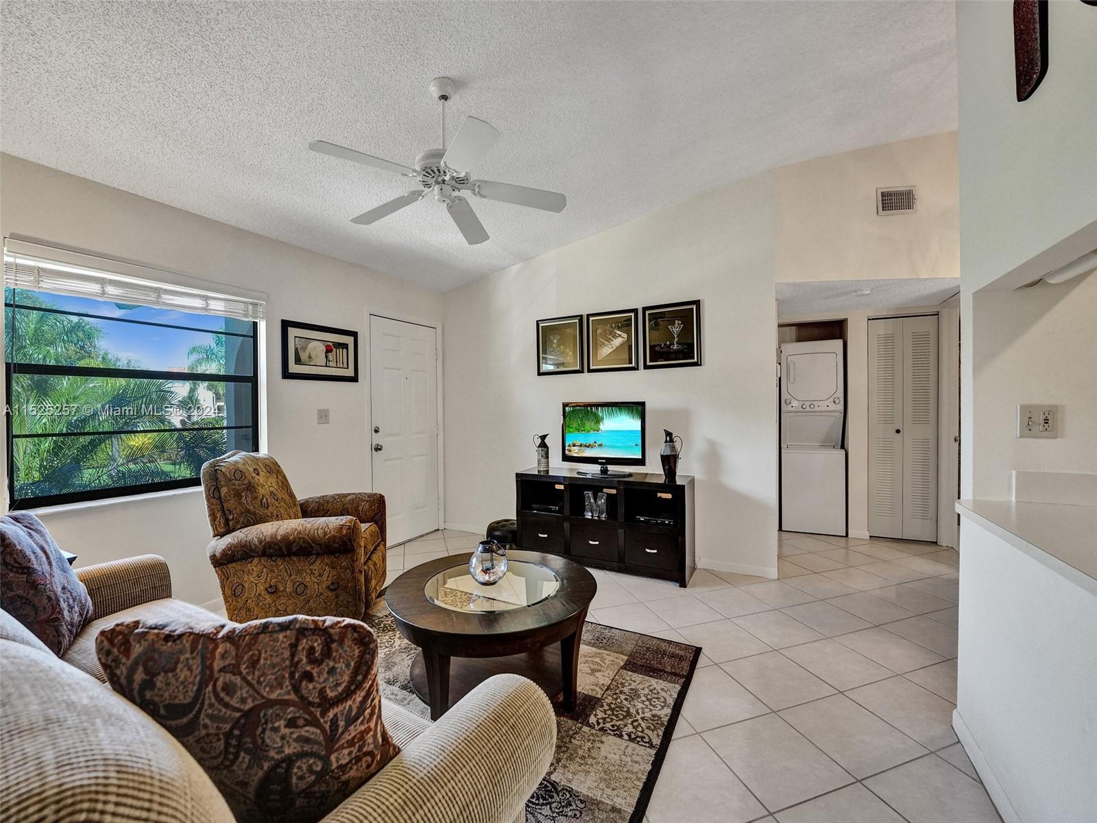 9480 Boca Cove Circle, Unit 416 Boca Raton, FL 33428 - Photo 3 of 25 a living room with furniture and a window