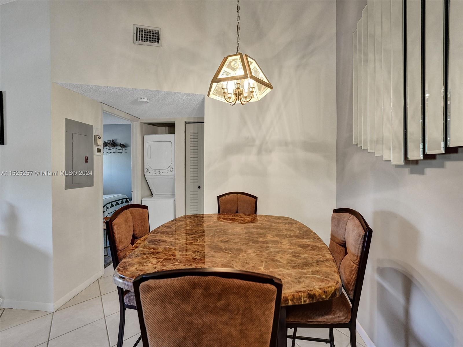 9480 Boca Cove Circle, Unit 416 Boca Raton, FL 33428 - Photo 7 of 25 a view of a dining room with furniture and window