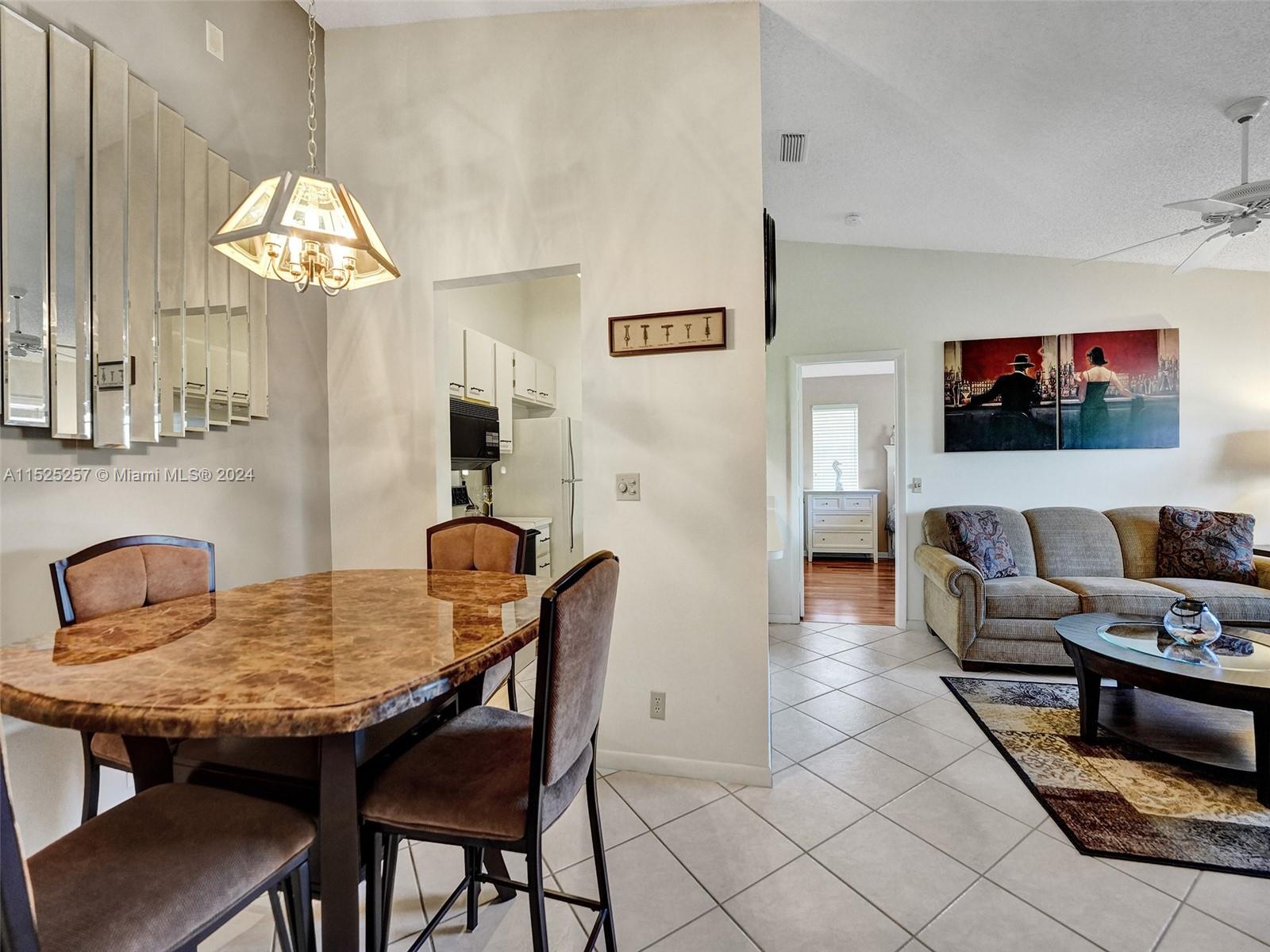 9480 Boca Cove Circle, Unit 416 Boca Raton, FL 33428 - Photo 8 of 25 a view of a dining room with furniture