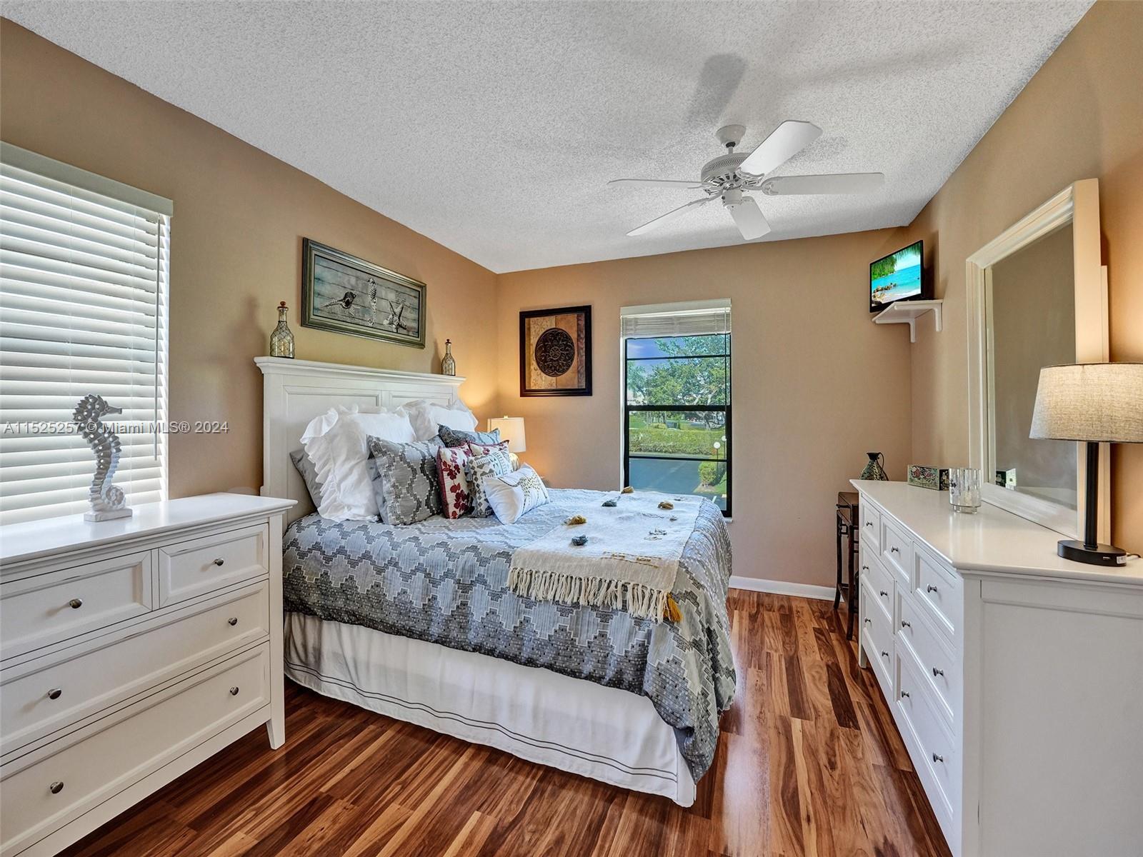 9480 Boca Cove Circle, Unit 416 Boca Raton, FL 33428 - Photo 9 of 25 a bedroom with a bed and a dresser