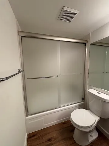 a bathroom with a toilet and a shower